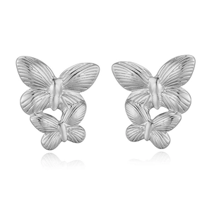 Detailed view of silver double butterfly stud earrings with polished metallic finish