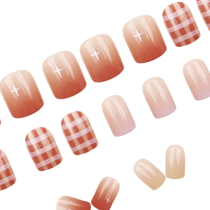 Short square press-on nails with orange gradient, star patterns and red plaid designs
