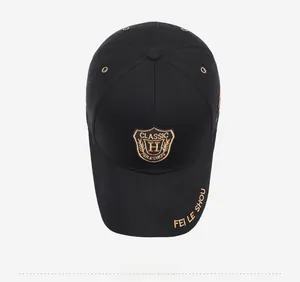 Top view of black baseball cap with golden shield embroidery and ventilation eyelets