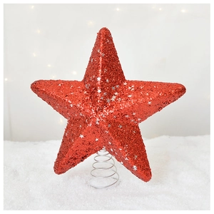 Close-up of red glitter Christmas tree topper star with silver sequins on a spiral base