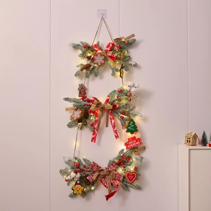 Close-up of triple-layered Christmas garland with pine needles, red bows and warm LED lights