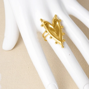 Minimalist gold heart ring with beaded edges and adjustable opening on white hand model