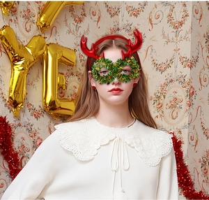 Detailed view of red sequin reindeer headband and green wreath glasses for Christmas party