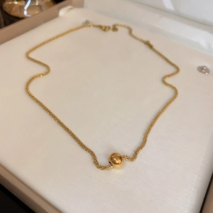 Titanium steel gold bead necklace displayed on a minimalist white jewelry gift box