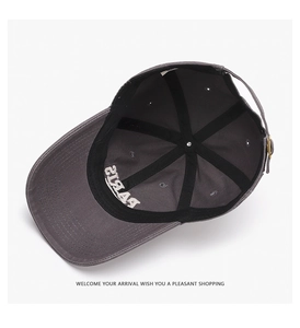 Detail view of cotton baseball cap interior featuring PARIS embroidery and metal buckle