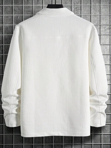 Detailed close-up of white waffle texture knit jacket with geometric jacquard patterns