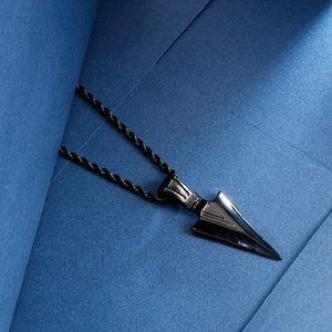 Detailed close-up of a black stainless steel arrowhead pendant on a twisted chain