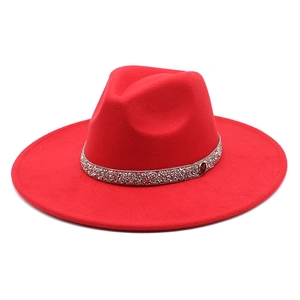 Detail of red wool felt fedora featuring a silver sequin band with a metal M buckle