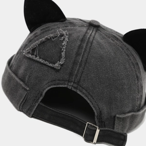 Macro detail of washed denim miki hat with cat ears and adjustable metal buckle