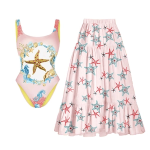 Detail of pink starfish and seahorse print on a one-piece swimsuit with yellow lining