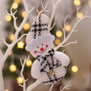 Charming snowman Christmas ornament with black and white plaid fabric on white branches