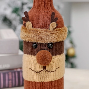 Close-up of reindeer wine bottle cover featuring knitted texture and festive plush antlers