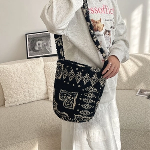 Detail of plush black and white geometric pattern shoulder bag for winter styling