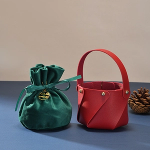 Green velvet drawstring pouch and red leather festive gift bag with Merry Christmas tag