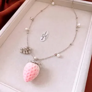 Pink velvet strawberry pendant necklace with white pearls on a silver-tone chain