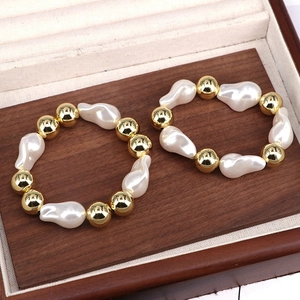 Elegant baroque pearl and gold bead adjustable bracelet displayed in a wooden jewelry box