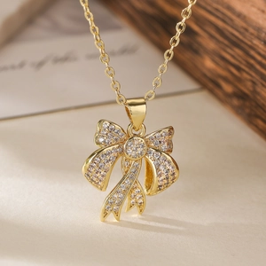 Elegant gold bow pendant necklace with zircon stones on a minimalist chain for women