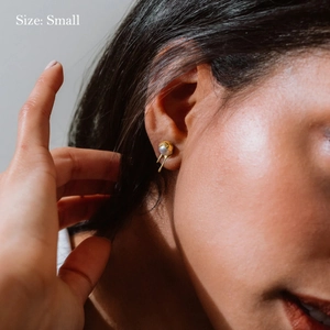 18K gold teardrop pearl earrings in small size worn on ear with minimalist design