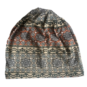 Detail of bohemian beanie featuring intricate mandala patterns and daisy ornaments