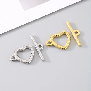 Macro detail of gold and silver twisted heart OT toggles for DIY jewelry making