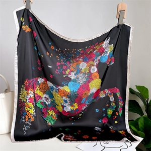 Square silk scarf with black floral horse pattern displayed on a white wall