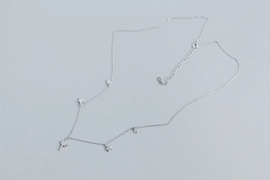 Macro detail of S925 sterling silver star necklace with sparkling crystal pendants