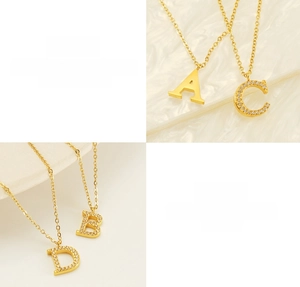 Detailed macro view of gold-plated titanium steel necklaces with A B C D letter pendants