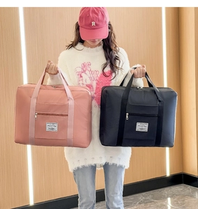 Close-up of pink and black travel bags with wide straps and spacious zipper pockets