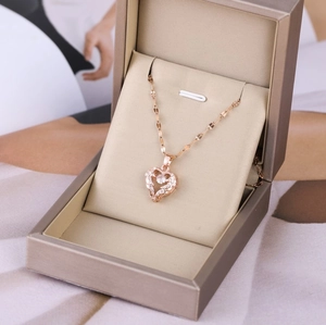 Rose gold heart pendant necklace with white crystals in a premium jewelry gift box
