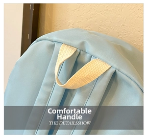 Detailed close-up of the comfortable woven handle on a cute light blue children backpack