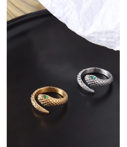 Detailed view of snake-shaped ring with green gem eyes in gold and silver finish