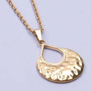 Detail of 18k gold plated stainless steel necklace with hammered teardrop pendant