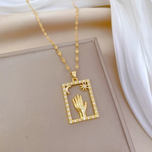 Luxurious gold stainless steel necklace featuring a crystal-encrusted celestial Hamsa pendant