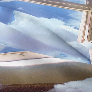 Close-up of bohemian wall tapestry showing soft fabric texture and blue sky print