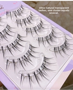 Macro detail of cluster sunflower false eyelashes with transparent base on purple tray