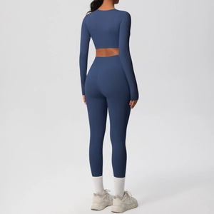 Rear view of navy blue high-waist yoga pants and cropped long-sleeve athletic set