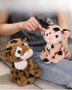 Close-up of soft leopard plush toy being squeezed to show the fluffy and skin-friendly fabric