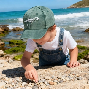 Kids vintage washed dark green baseball cap featuring white dinosaur skeleton embroidery