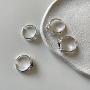 Macro shot of silver S925 rings featuring bubble bead design and rectangular zircon accents