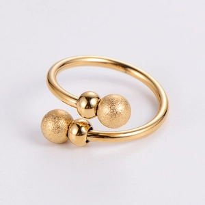 Detail view of golden adjustable ring with polished and matte textured ball finials