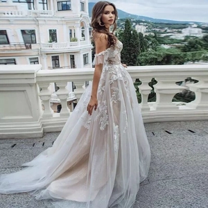 Elegant off-shoulder white lace wedding dress with champagne lining and long train