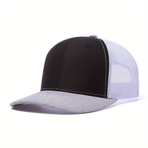 Detail view of trucker hat showing black cotton front and breathable white mesh back