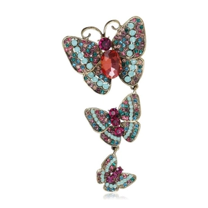 Vintage bronze butterfly brooch with colorful rhinestones and red gemstone on white background