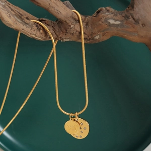 Golden snake chain necklace with Good Luck round plaque and zircon moon pendant