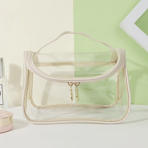 Clear waterproof PVC makeup bag with beige fabric trim and gold double zippers for travel