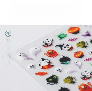 Macro shot of 5D Halloween nail art stickers with cute pumpkin and ghost patterns
