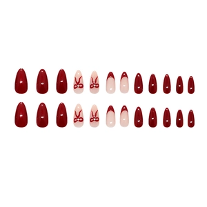 Glossy burgundy cat eye press-on nails with French tips and sweet red bow designs