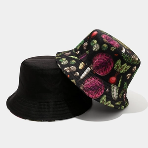 Detail of reversible bucket hats in plain black and vibrant vegetable pattern prints