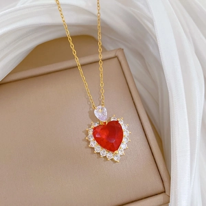 Detailed close-up of a luxury red heart pendant necklace with shimmering clear zircons