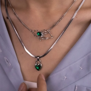 Silver layered necklace set with green heart pendant and emerald spider charm jewelry